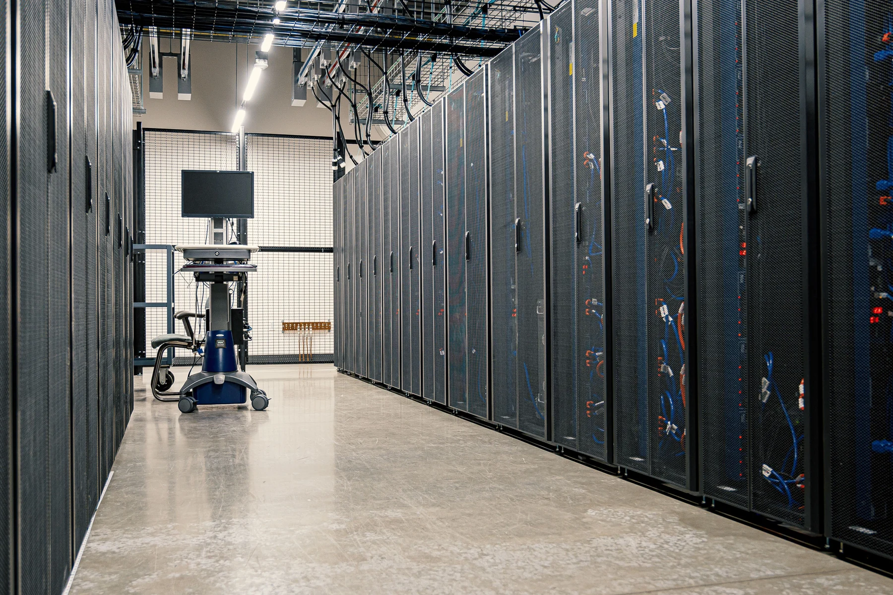 Organized server racks containing enterprise computing and networking equipment